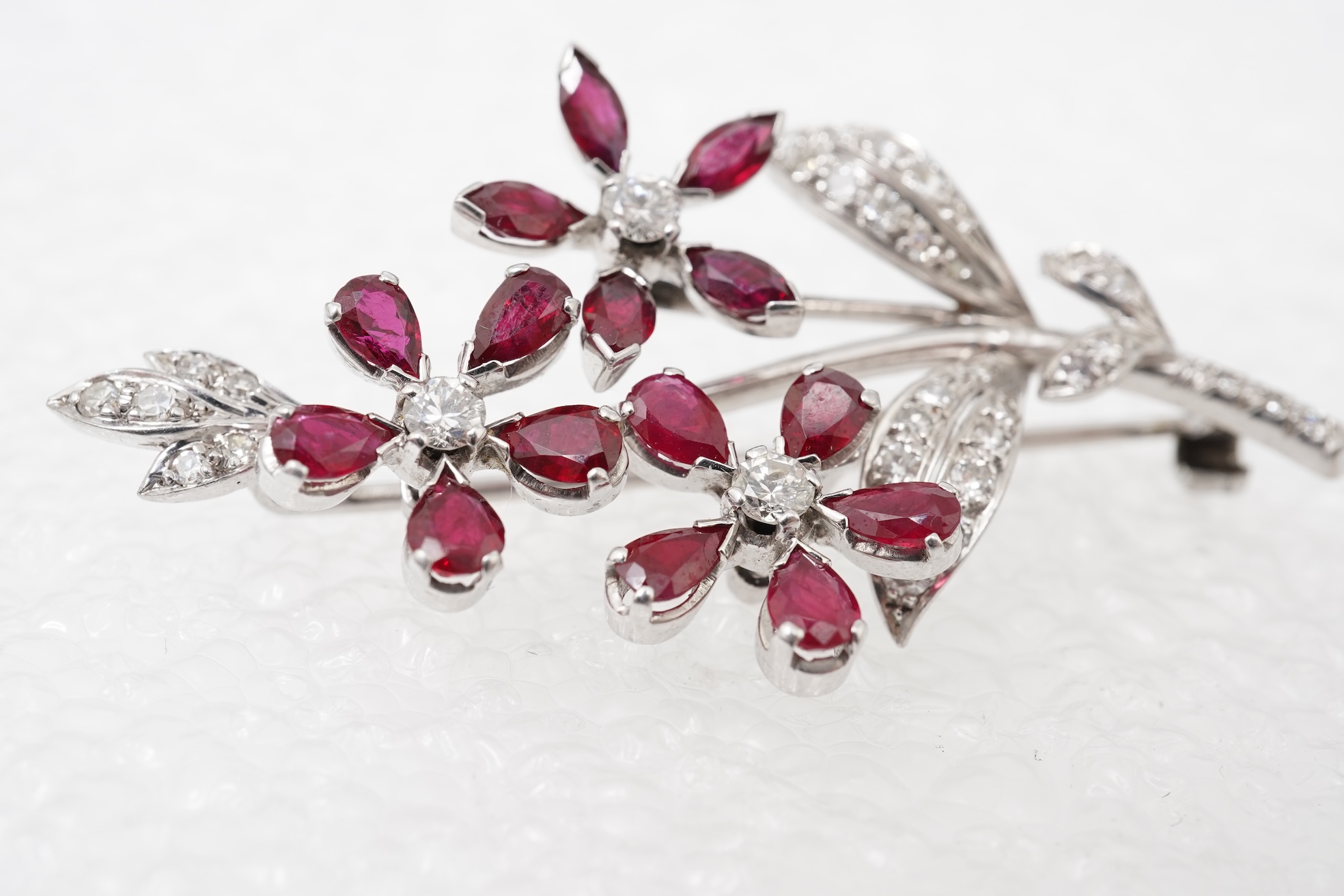 A ruby and diamond floral spray brooch
